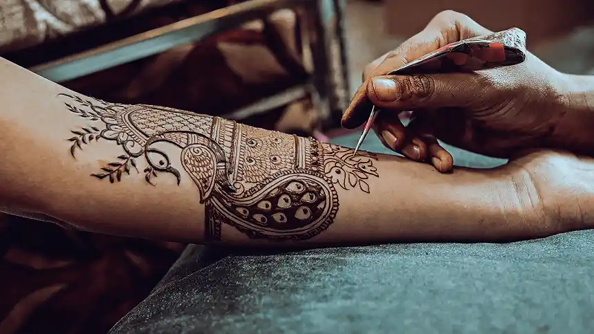 Henna tattoo applied on bride's hands