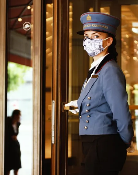 Kempinski Hotels Entrance Door Lady Mask and gloves - ALO Magazine